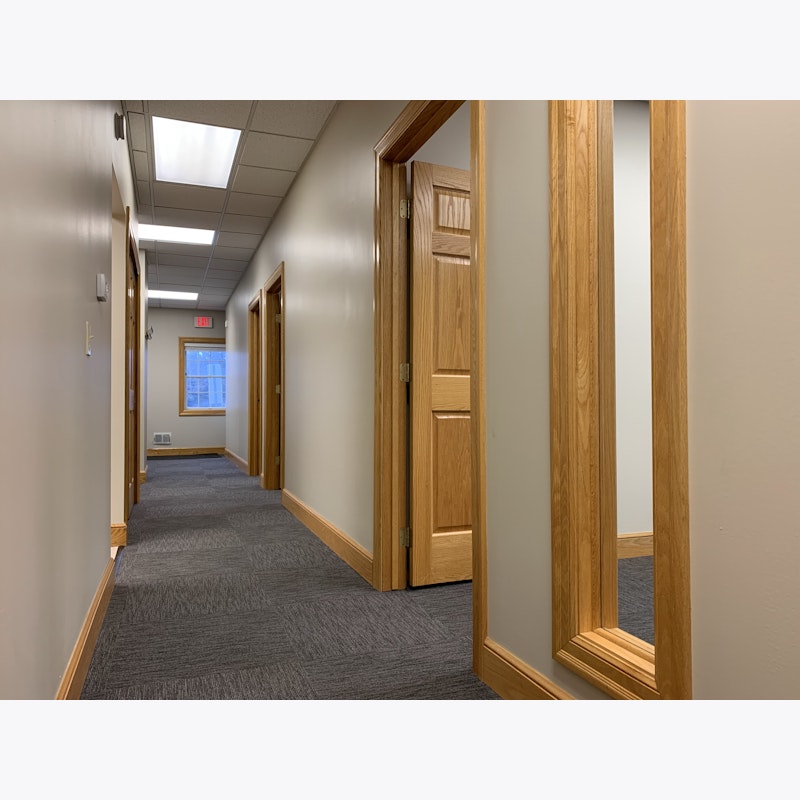 hallway of suite with panel for conference room